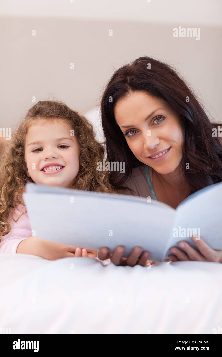 Mother and daughter reading bedtime stories together Stock Photo Alamy