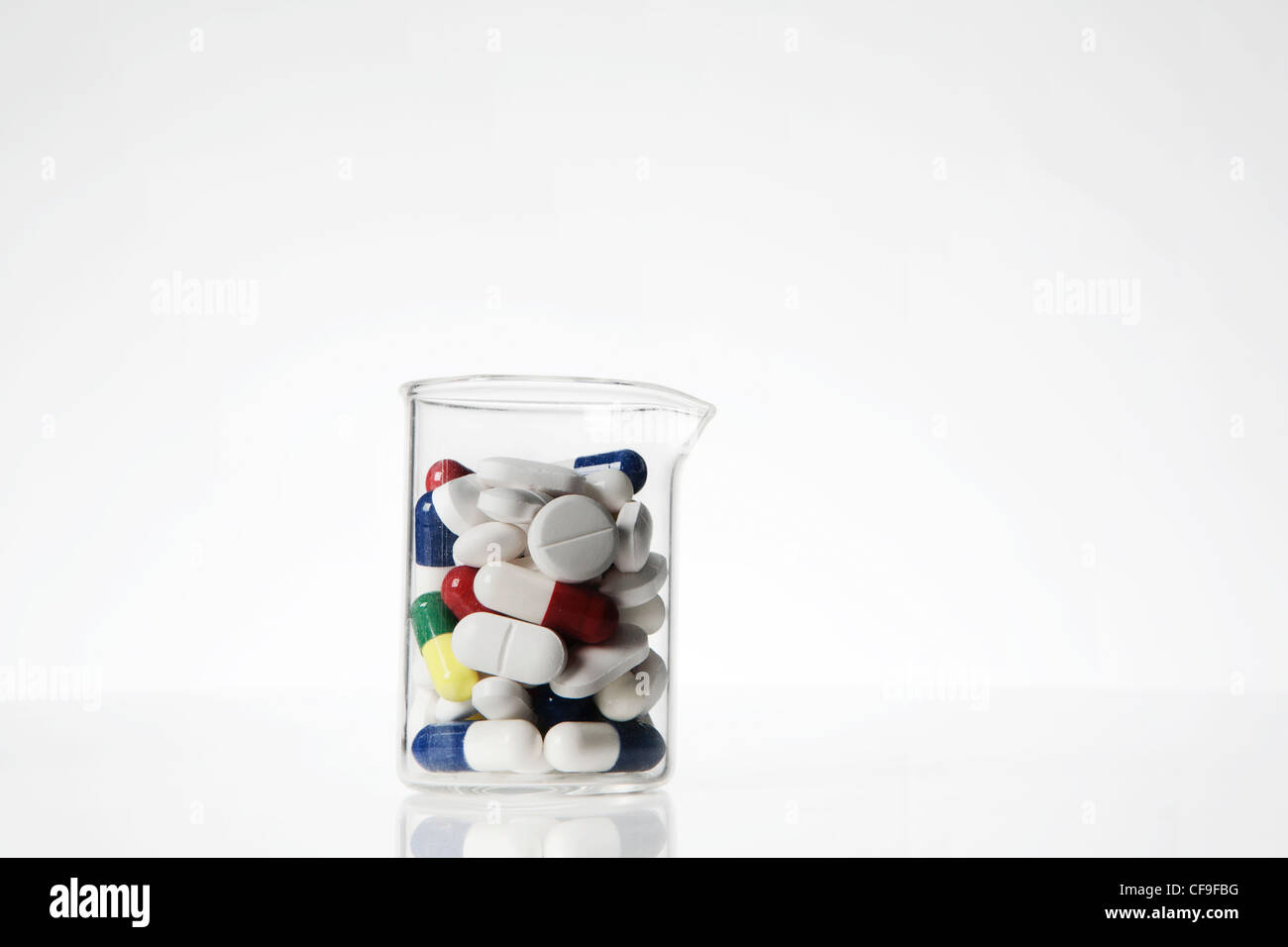 pills and tablets in laboratory beaker on a white background Stock ...