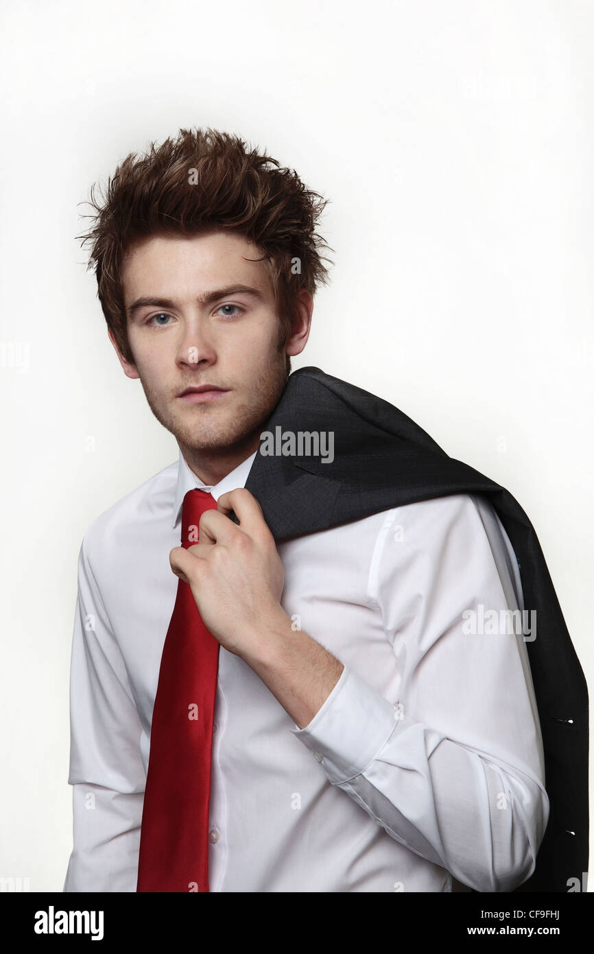 young casual looking businessman with his jacket off and over the