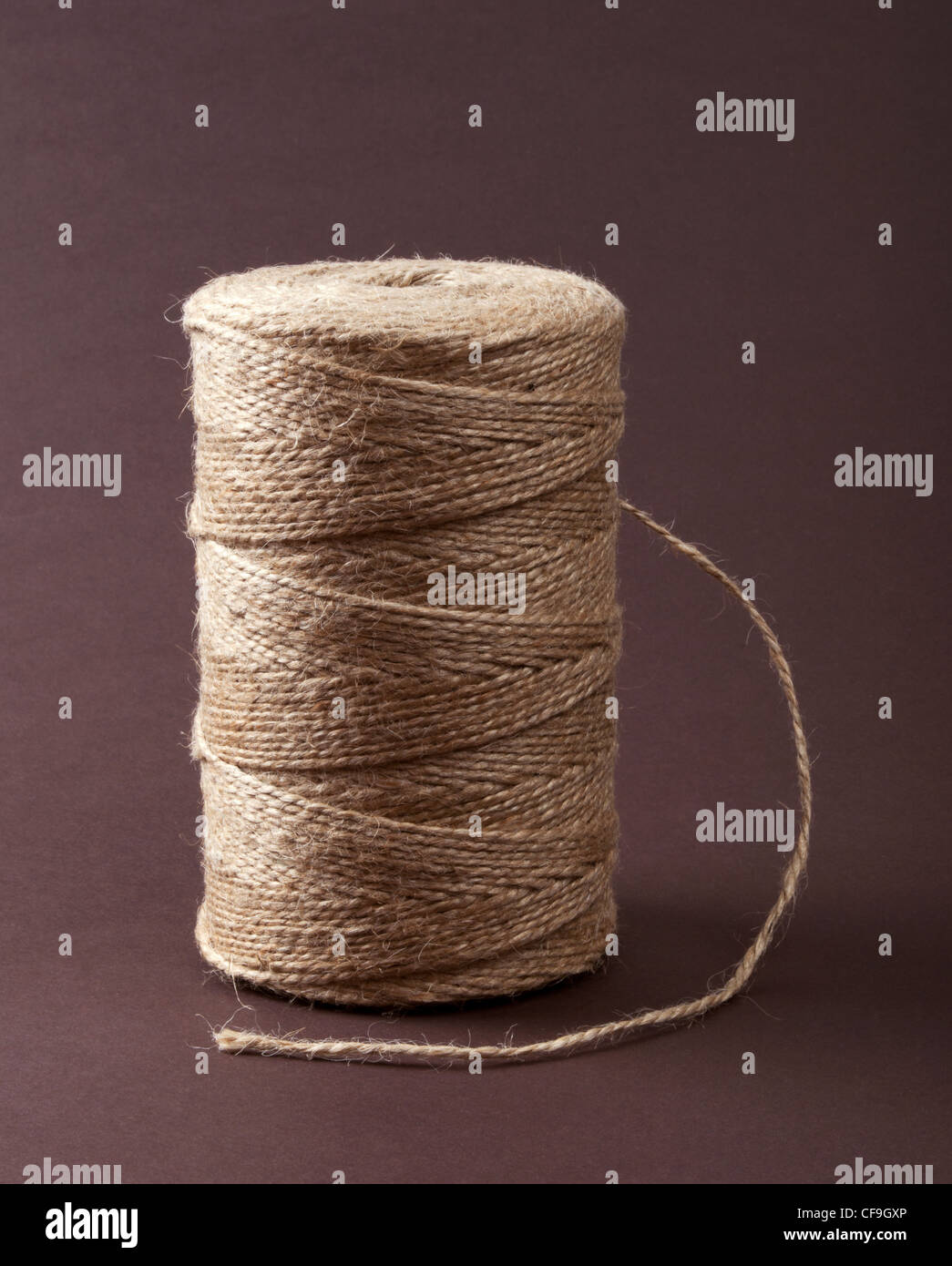 Roll of sisal rope on dark brown background Stock Photo