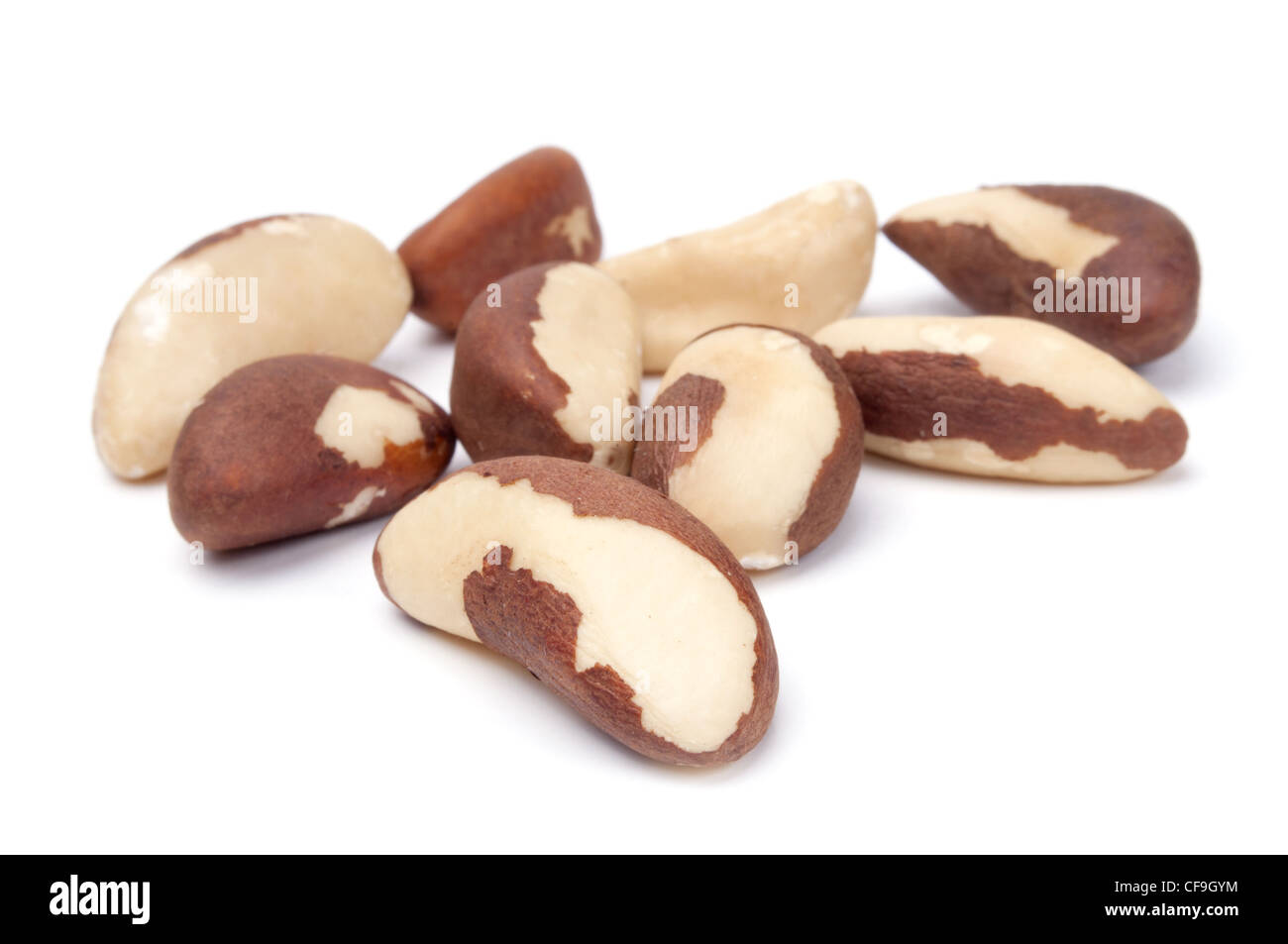 heap of brazil nuts close-up isolated on white background Stock Photo