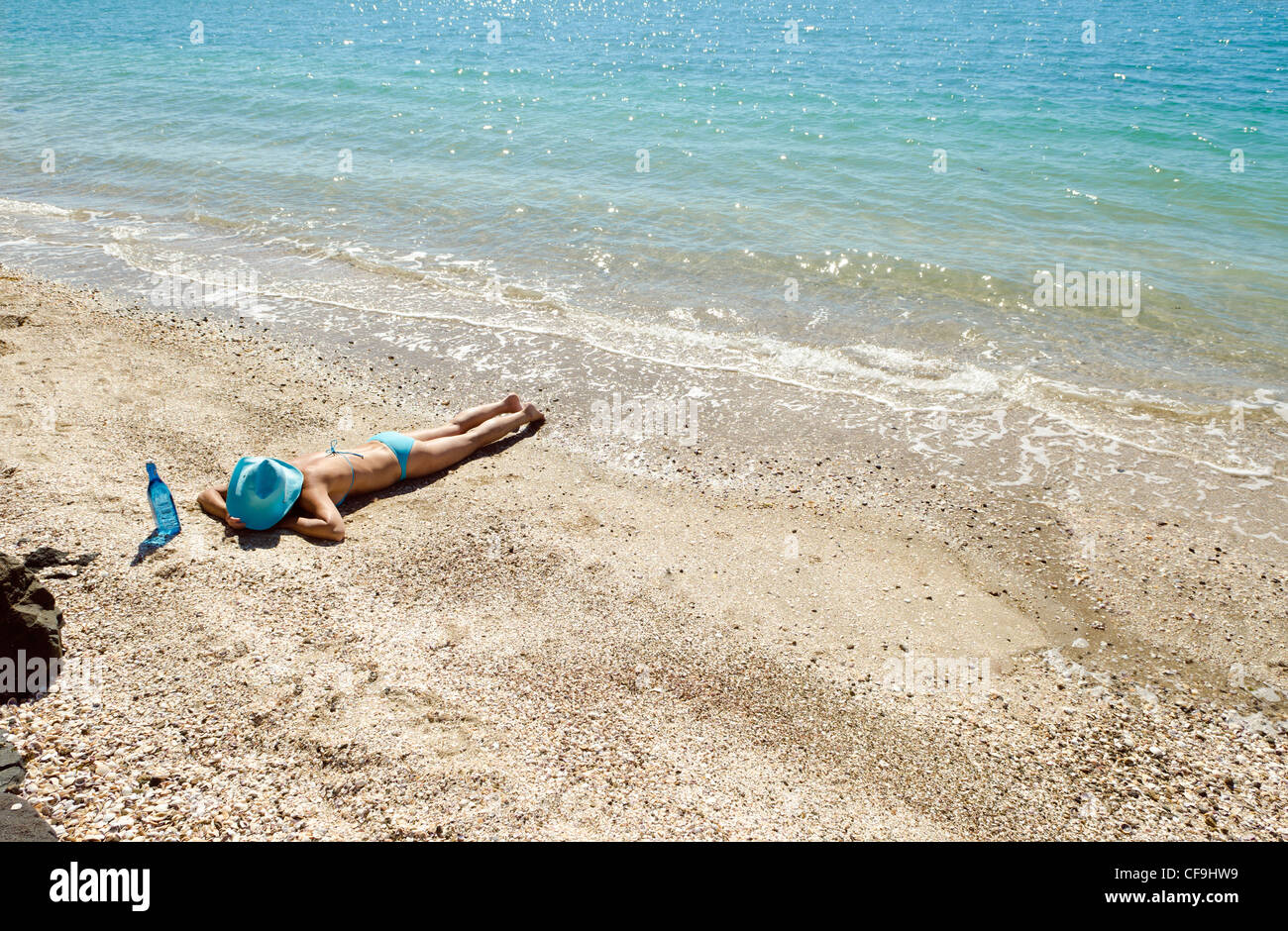 Lady laying on a beach hires stock photography and images Alamy