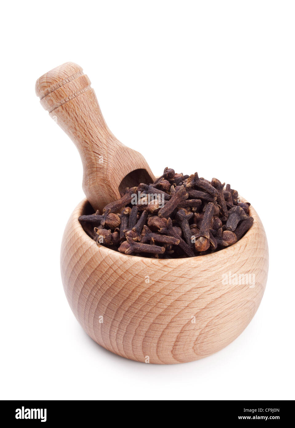 Wooden scoop in bowl full of cloves isolated on white background Stock Photo
