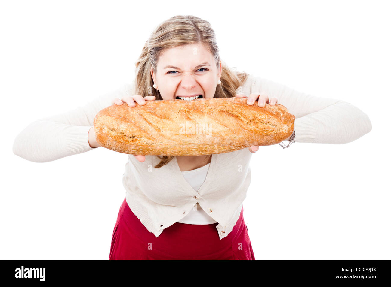 Hungry woman holding and biting loaf of bread, isolated on white background. Stock Photo