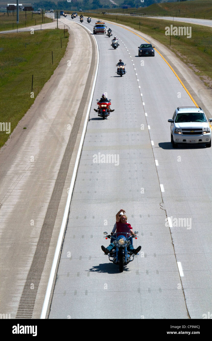 Motorcycles and automobiles travel on I-90 during Sturgis Motorcycle rally week west of Spearfish, South Dakota, USA. Stock Photo