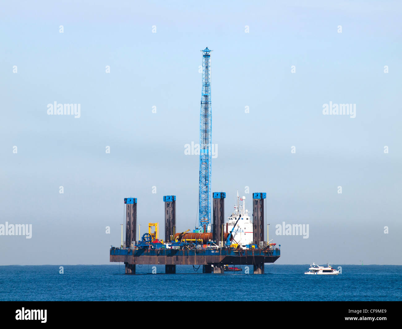 Jack-up construction vessel SEA JACK installing monopile foundations for Wind Turbines on the Teesside wind farm March 2012 Stock Photo