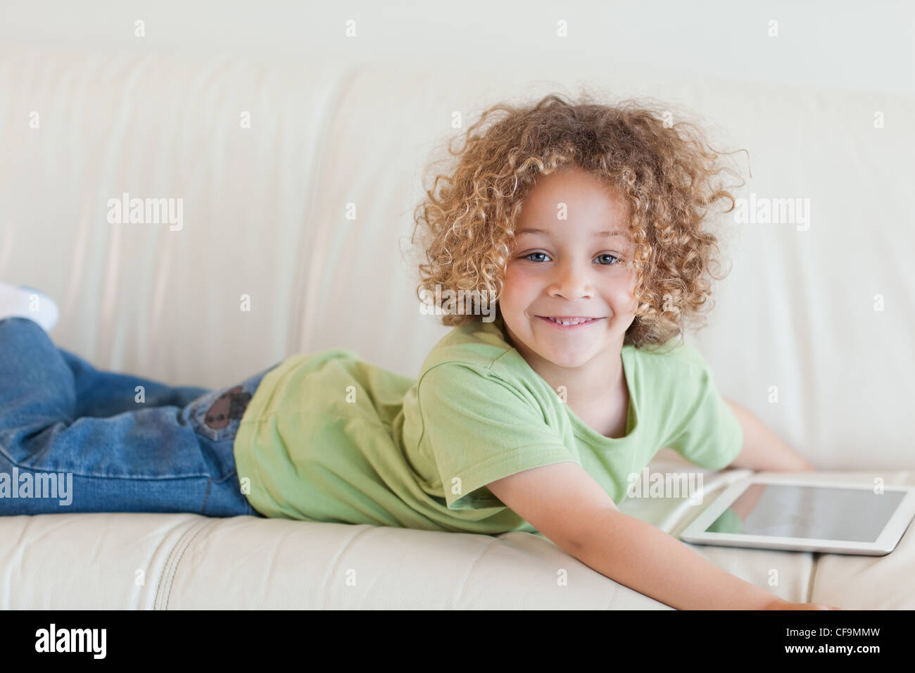 Smiling boy using a tablet computer Stock Photo - Alamy
