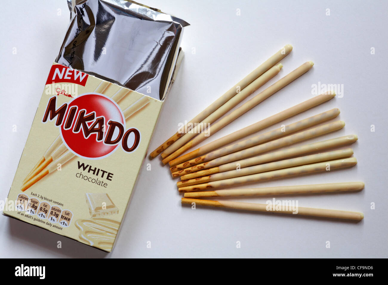 box of new Glico Mikado white chocolate opened to show contents set on white background - Mikado sticks Stock Photo