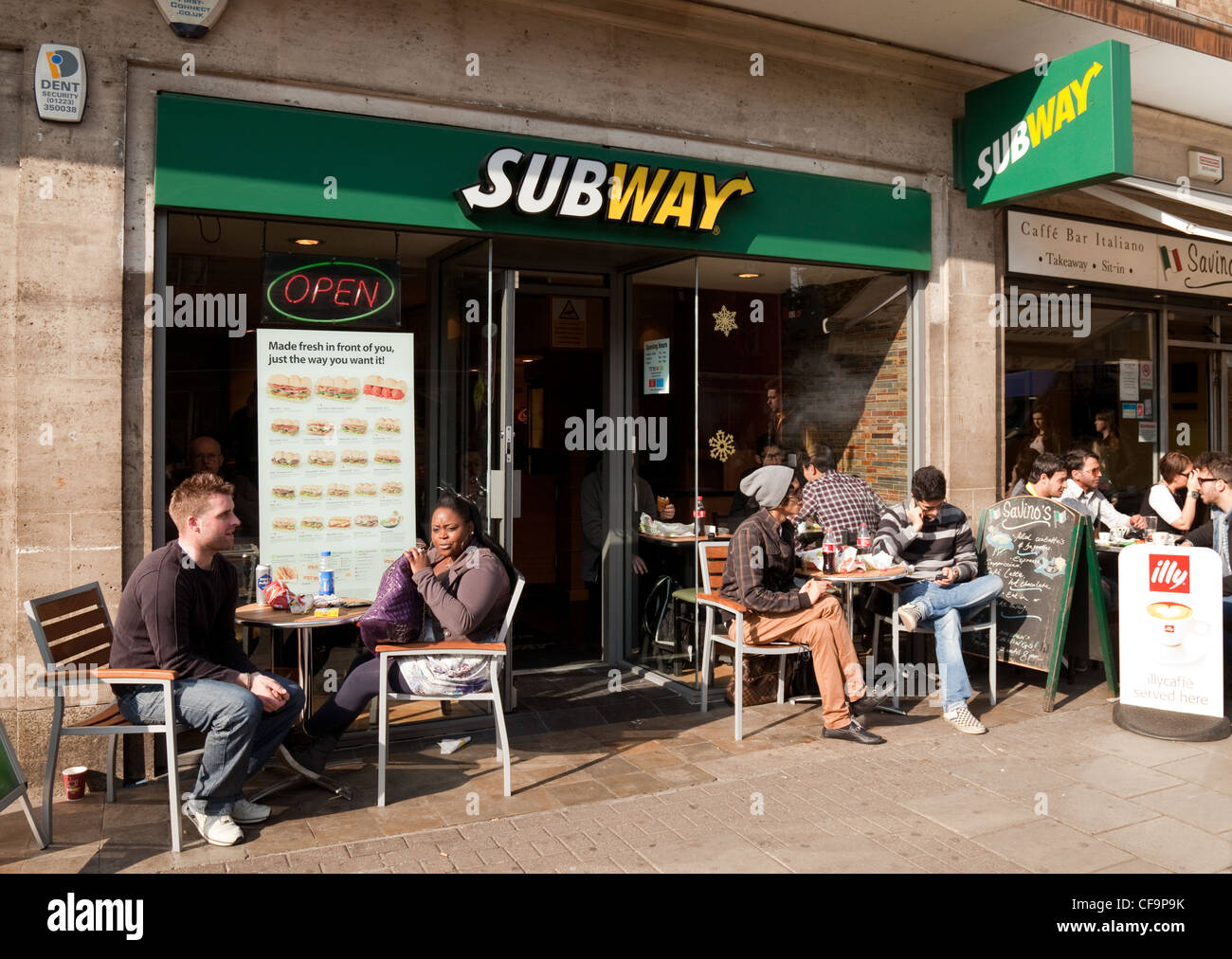people having a snack outside a Subway cafe, Cambridge UK Stock Photo