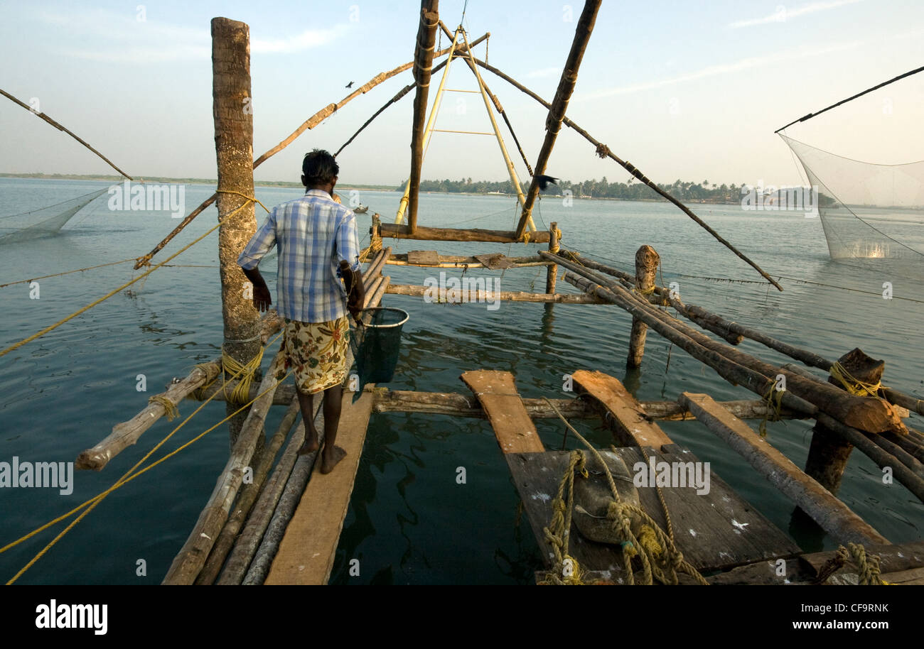 Indian fisherman using Chinese fishingnets in fort Kochi, India Stock Photo
