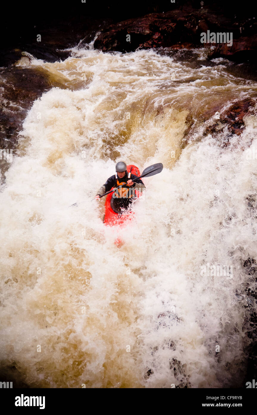 kayak about to drop of whitewater waterfall on the river nevis in
