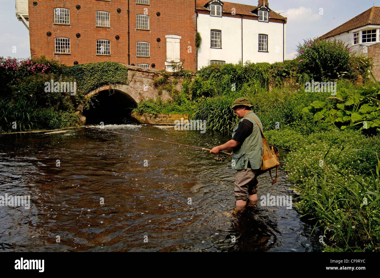 Fishing for trout by a water mill pond on a summers day England , UK, June Stock Photo