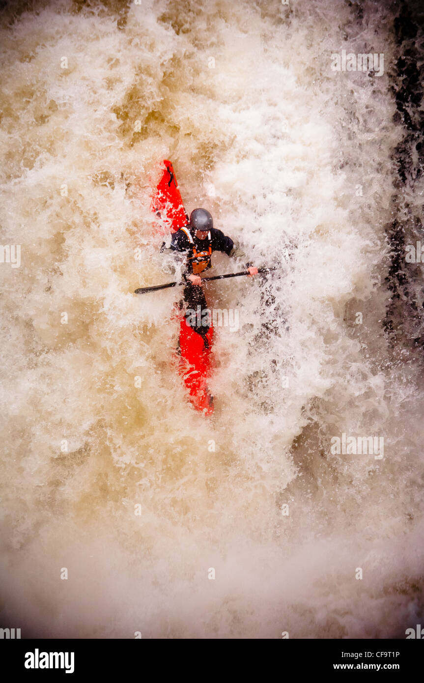 kayak about to drop of whitewater waterfall on the river nevis in