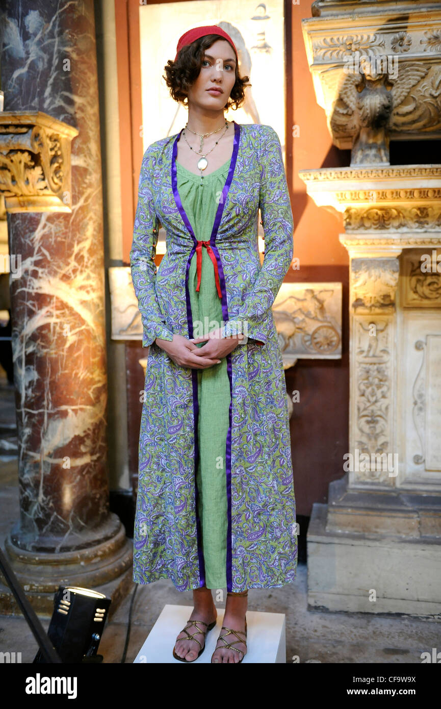 Agnes B Paris Ready to Wear Spring Summer Green and blue paisley print overcoat over long green dress, with red scarf Stock Photo