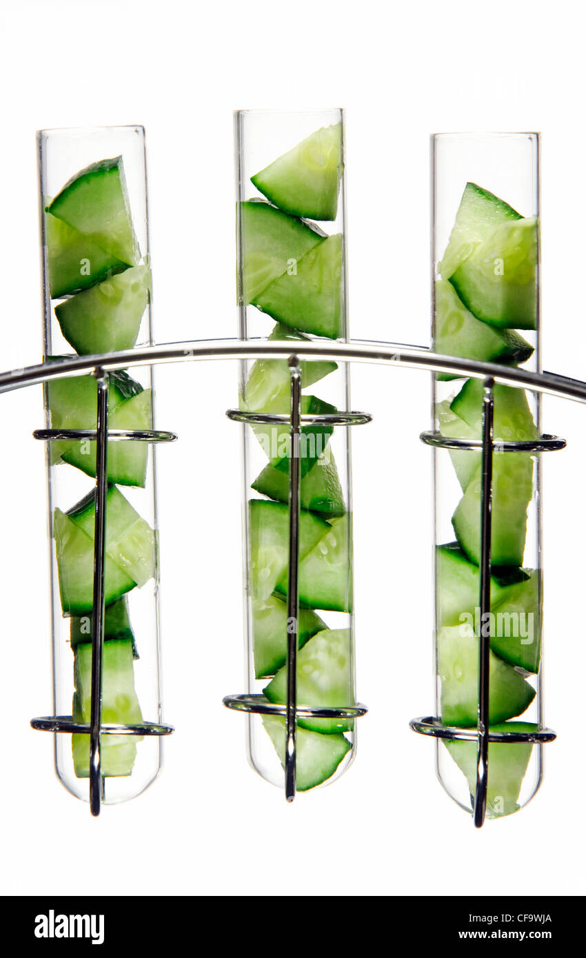Cucumber cut into small wedges in glass test tubes in a chrome stand