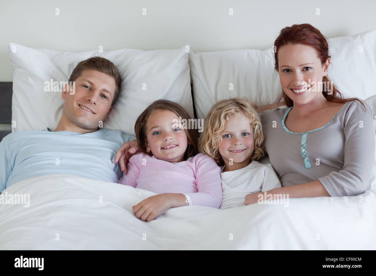 Family sharing the bed Stock Photo Alamy