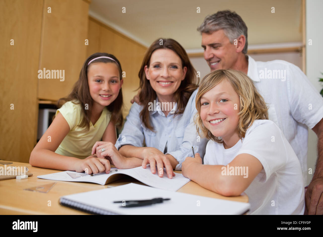 Parents helping children with homework Stock Photo - Alamy