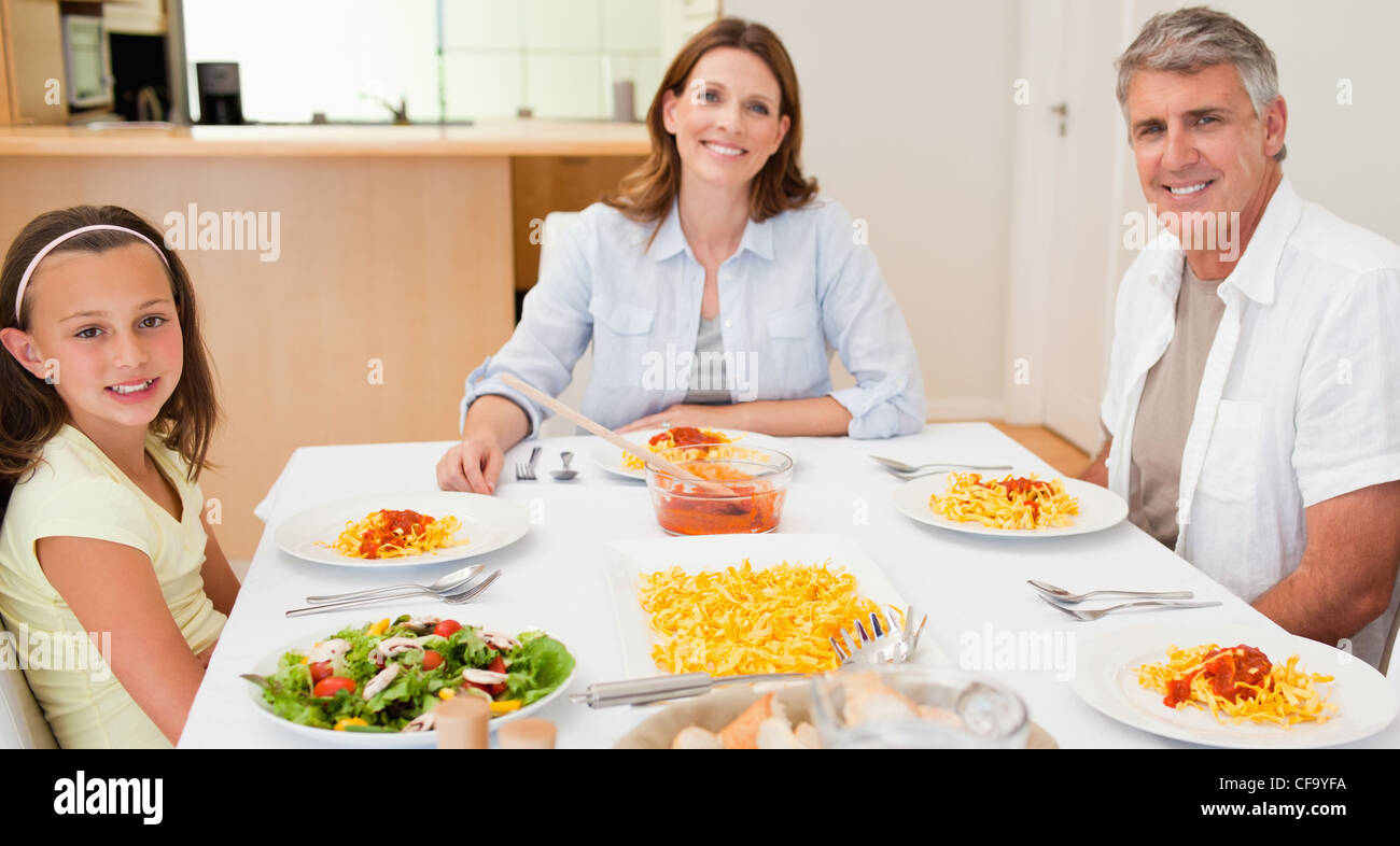 Happy family sitting together table hi-res stock photography and images ...