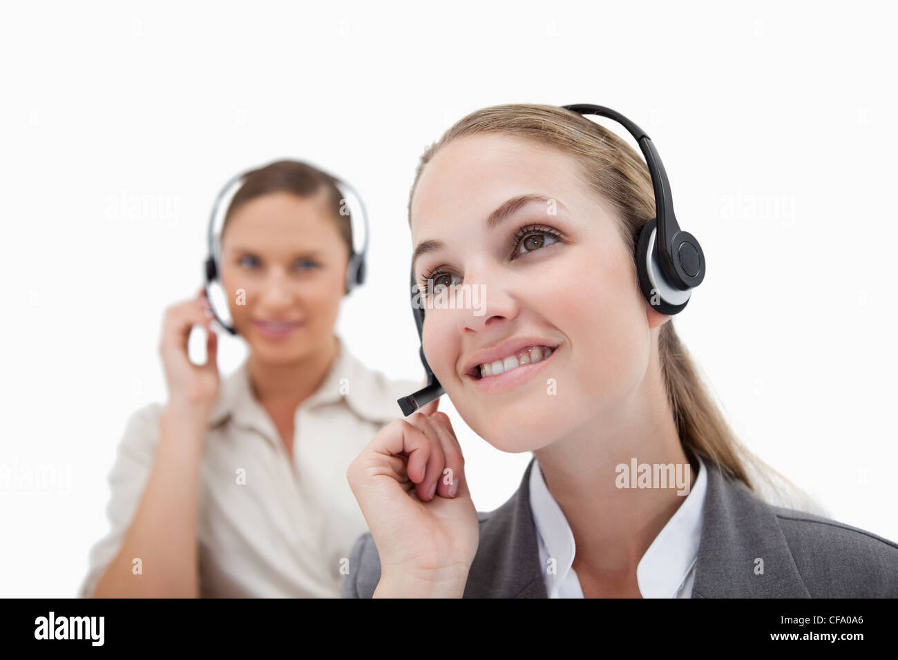 Smiling operators using headsets Stock Photo
