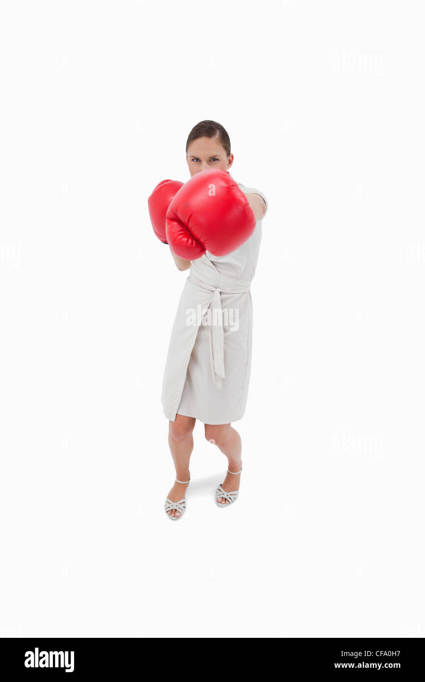 Portrait of a serious businesswoman punching someone Stock Photo