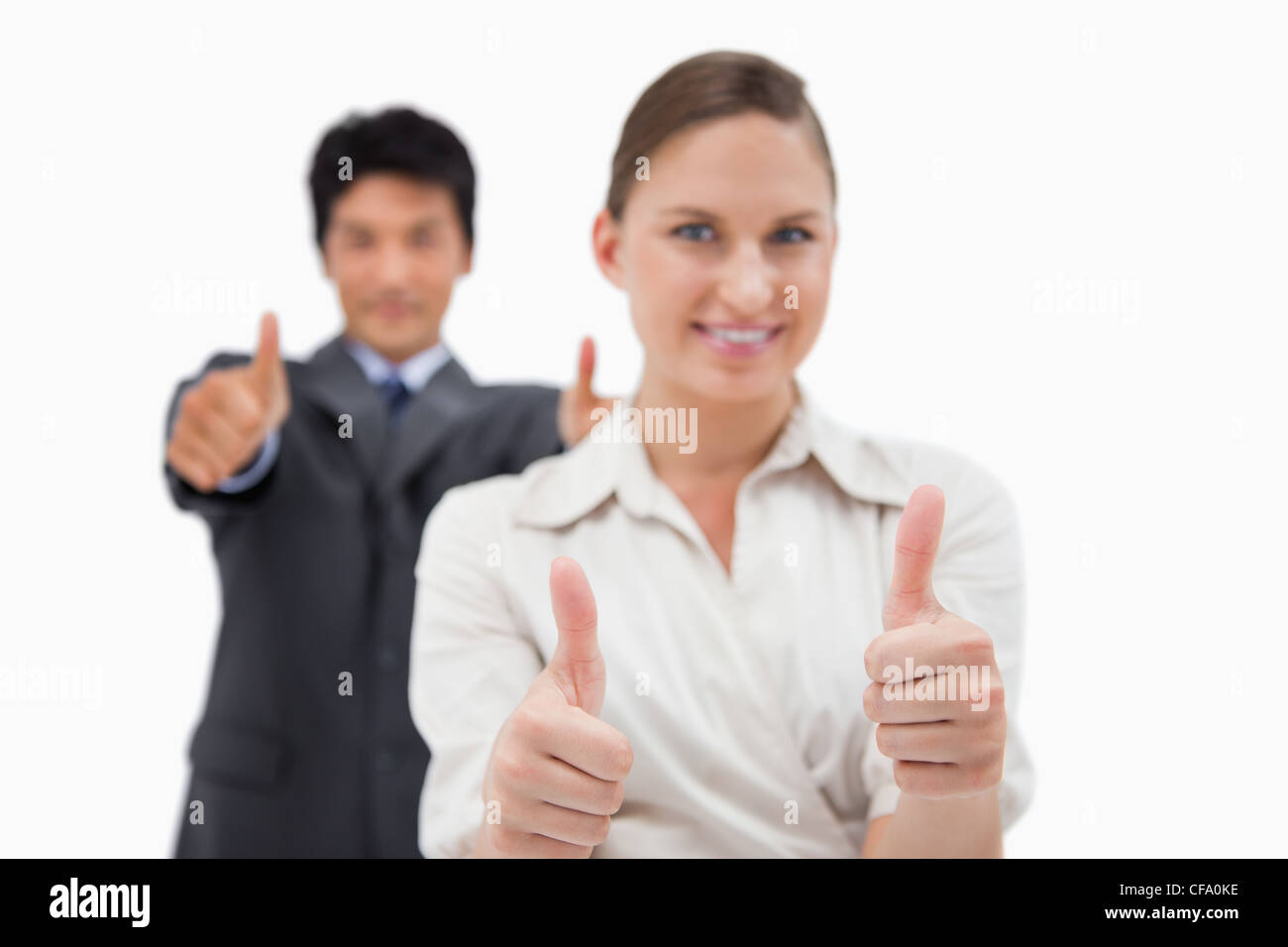 Smiling business people with the thumbs up Stock Photo - Alamy