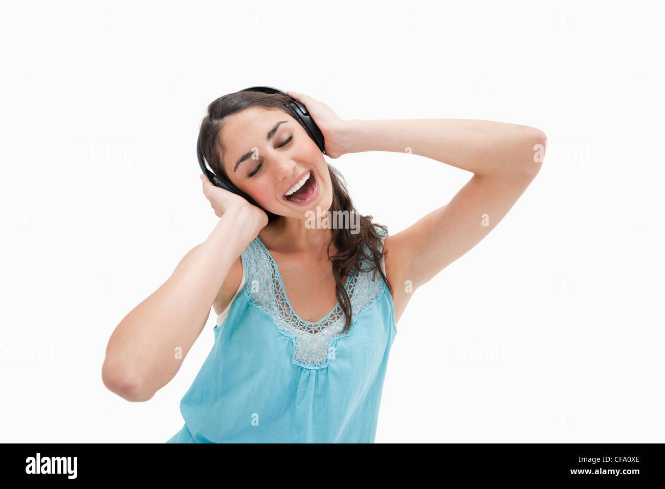Woman singing while listening to music Stock Photo