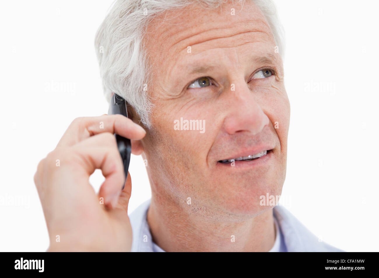 Mature man making a phone call while looking up Stock Photo