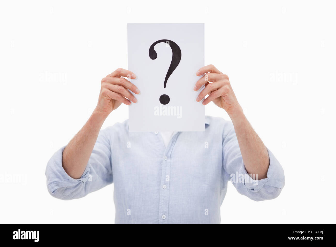 Portrait of a man hiding his face behind a question mark Stock Photo