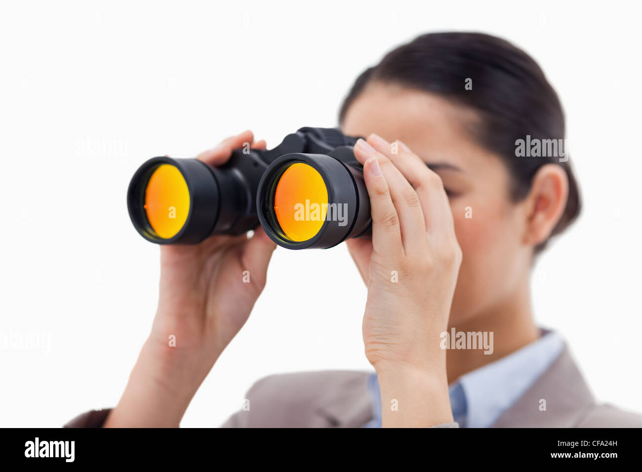 Brunette businesswoman looking through binoculars Stock Photo