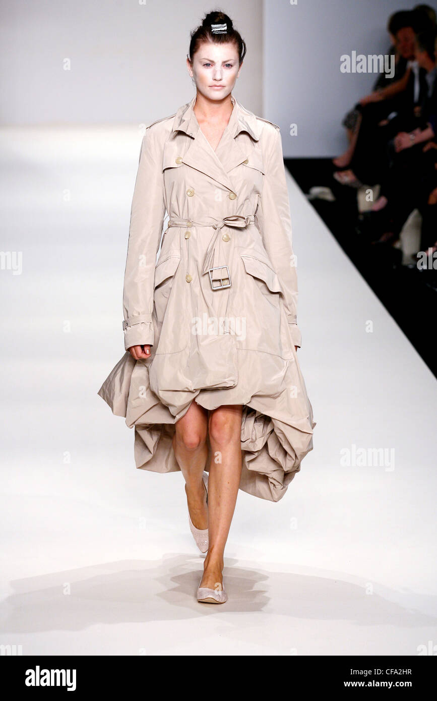 John Rocha London Ready to Wear Spring Summer White powder, salmon puffball trench coat and matching flat pumps Stock Photo