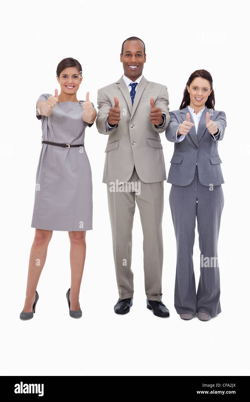 Smiling Business team giving thumbs up Stock Photo