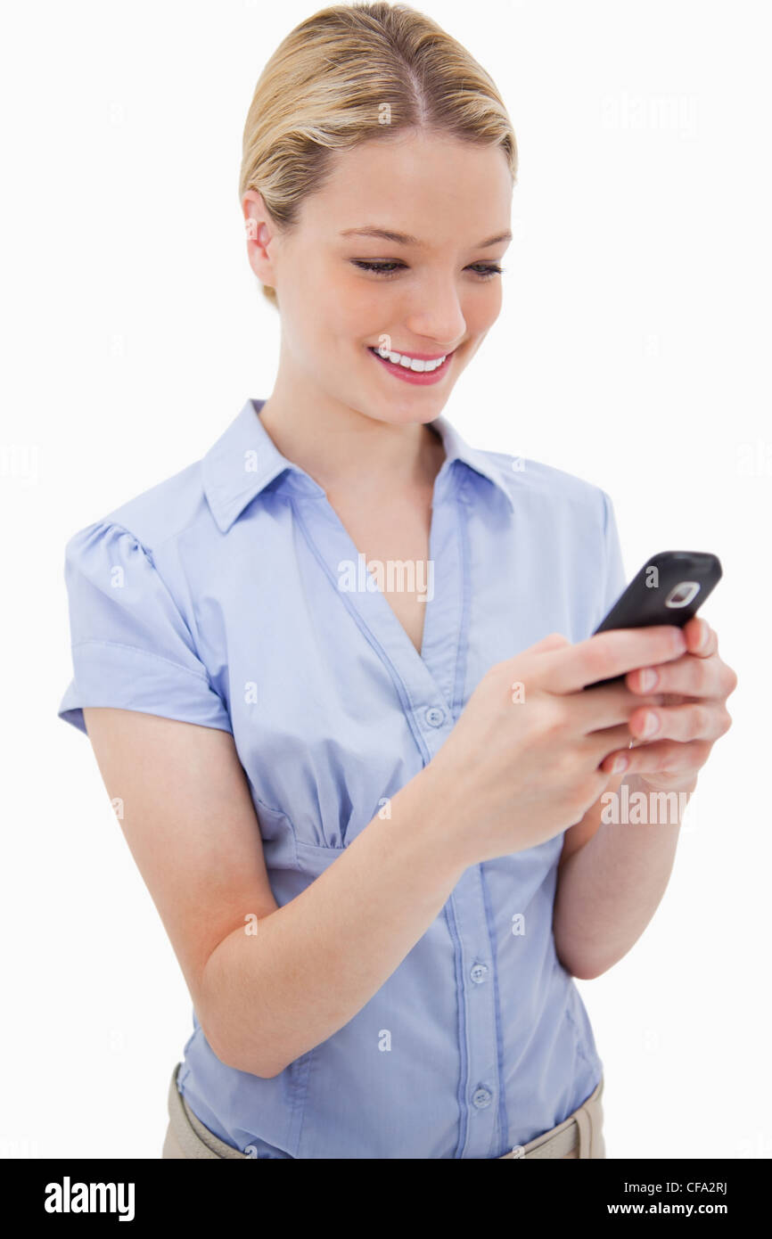 Smiling woman writing text message Stock Photo