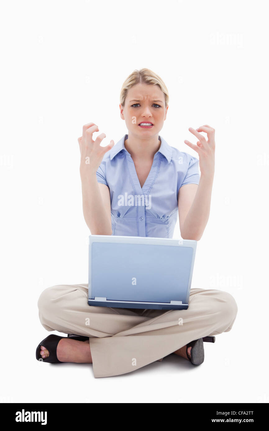 Sitting woman angry about her laptop Stock Photo