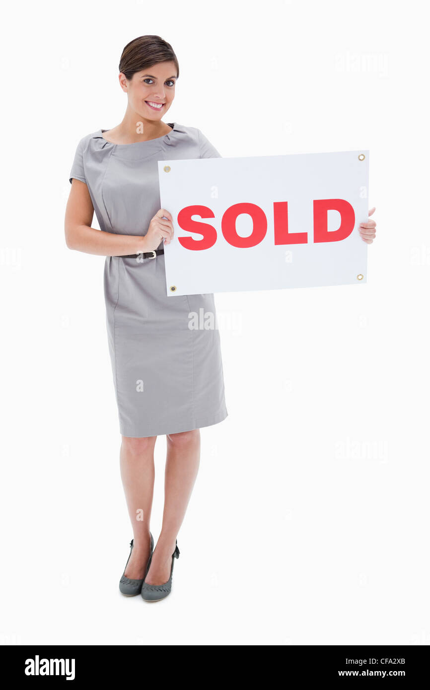 Woman holding sold sign in her hands Stock Photo