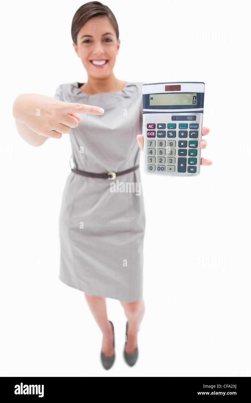 Woman pointing at hand calculator Stock Photo