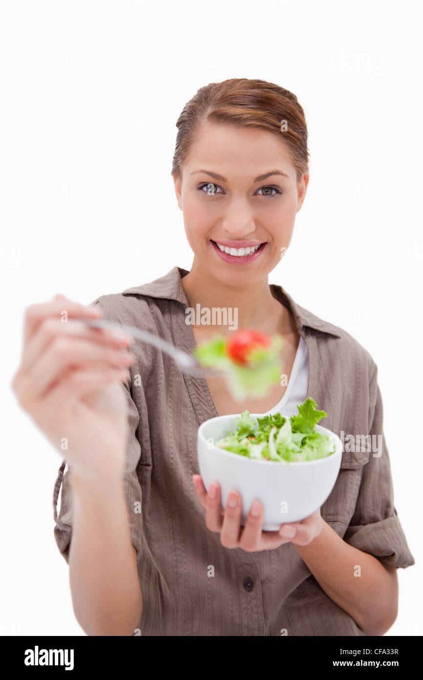 Woman with bowl of salad offering some Stock Photo