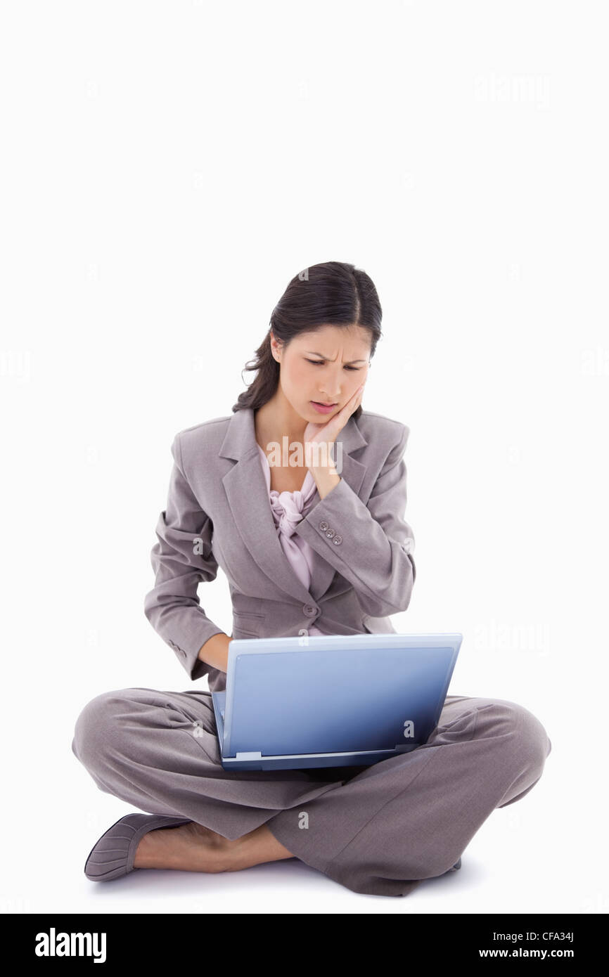 Sitting woman having trouble with laptop Stock Photo