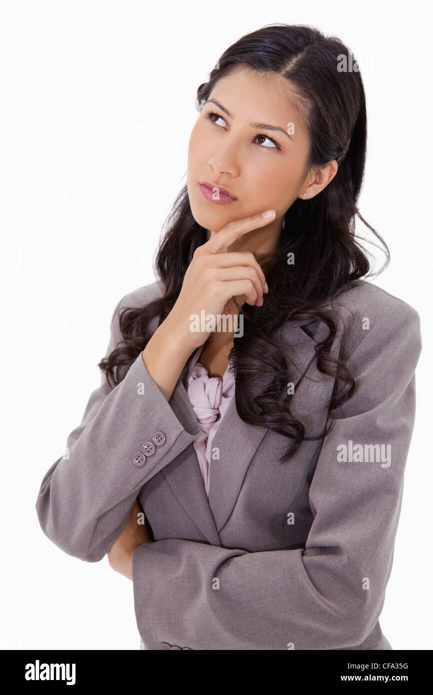 Thoughtful businesswoman touching her chin Stock Photo