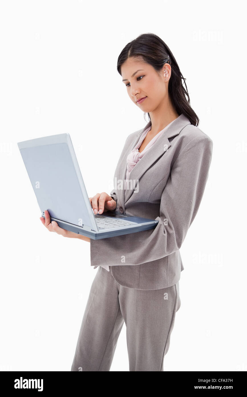 Side view of businesswoman standing with laptop Stock Photo