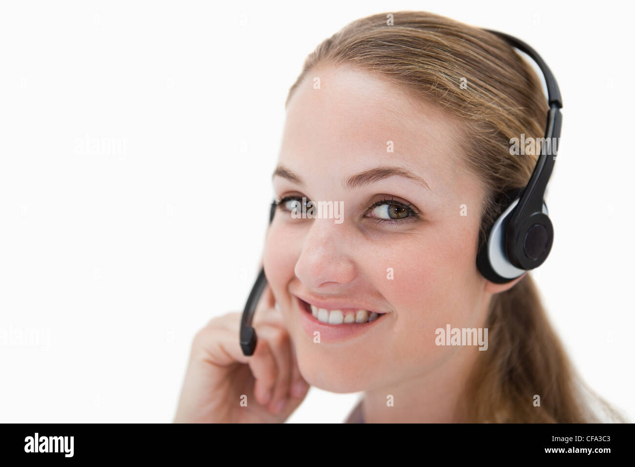 Side view of smiling call center agent with headset Stock Photo