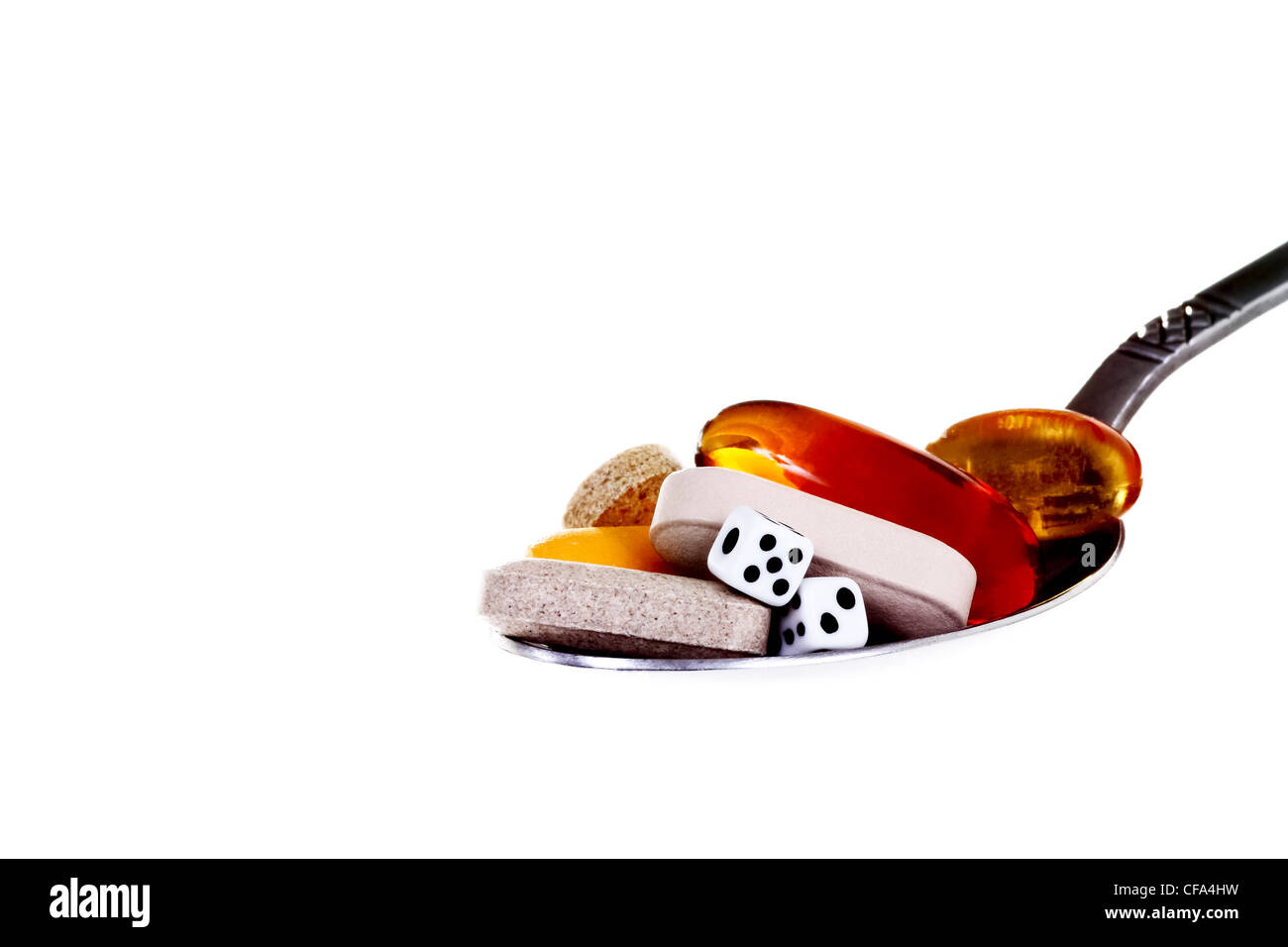 multi vitamins on spoon with dice Stock Photo