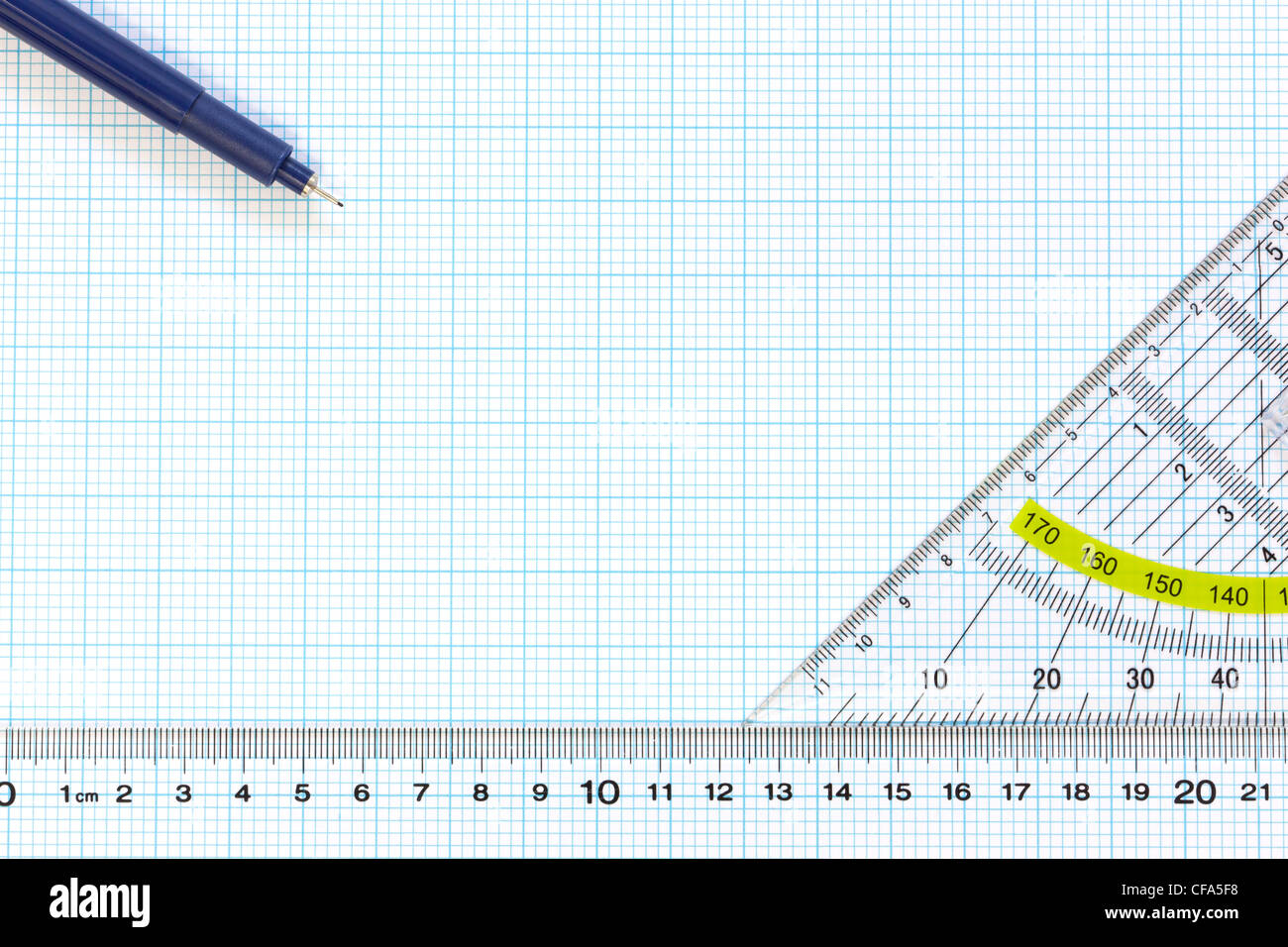 Still life photo of engineering graph paper with a fine 0.1mm pen, protractor and ruler Stock Photo