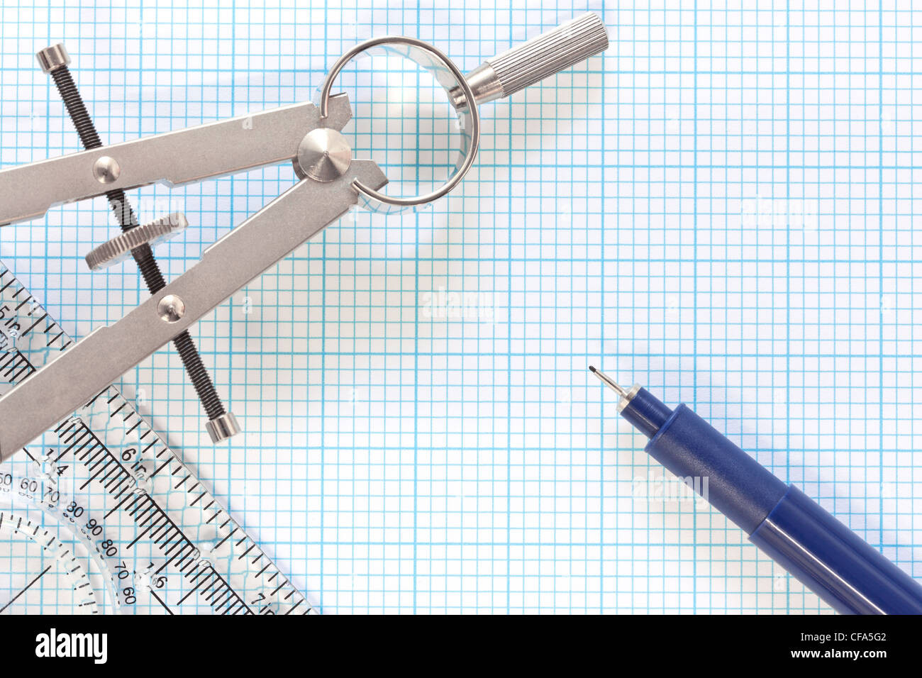 Still life photo of engineering graph paper with a fine 0.1mm pen, compass and ruler Stock Photo