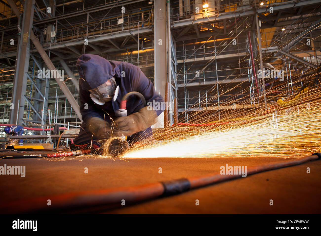 Steel cutter at work in shipyard Stock Photo