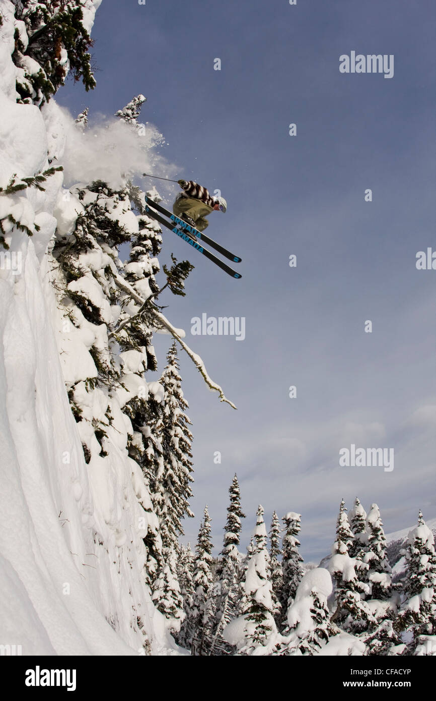 A male freeskier jumping a cliff at Sunshine Village, AB Stock Photo