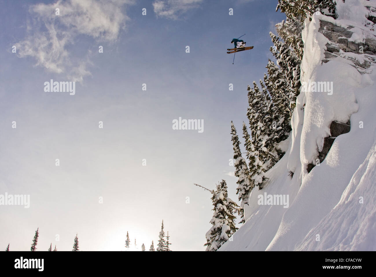 A male freeskier jumping a cliff at Sunshine Village, AB Stock Photo