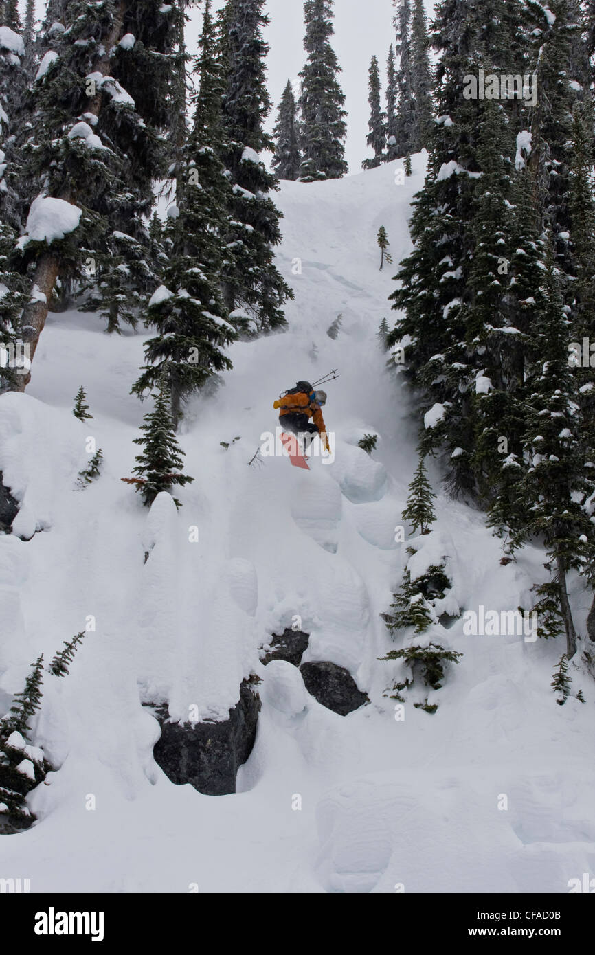 A male splitboarder catches some air at Fairy Meadows, Selkirks, BC Stock Photo