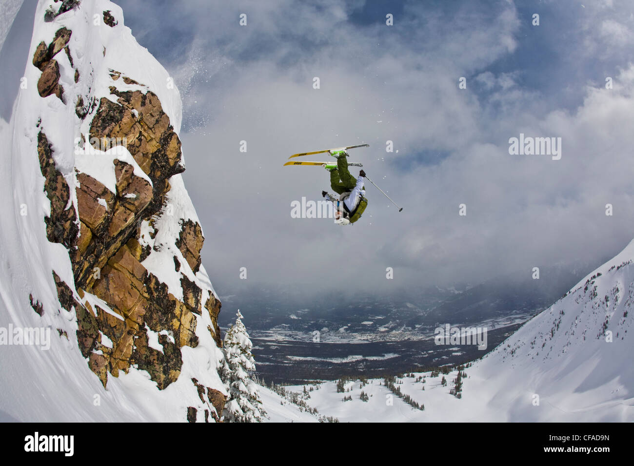 A male freeskier backflips in the Kicking Horse Backcountry, Golden, BC Stock Photo