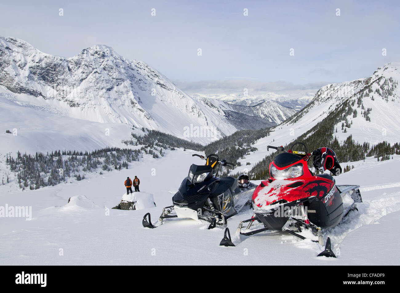 Two snowmobilers take breathtaking scene Monashee Stock Photo