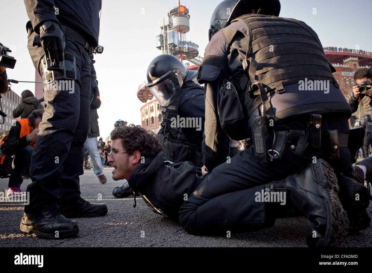 Arrest of a demonstrator by riot police during the disturbances produced in the vicinity of Mobile World Congress in Barcelona. Stock Photo